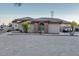 Beautiful home with a circular driveway, mature trees, and stucco exterior, providing a serene and inviting atmosphere at 9183 W Shamel Ash Rd, Peoria, AZ 85383