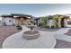 Stately home with a circular driveway, decorative fountain, and manicured landscaping, offering an impressive entrance at 9183 W Shamel Ash Rd, Peoria, AZ 85383