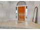 Welcoming foyer featuring a beautiful wood door, sidelight windows, and a decorative mirror, creating a grand entrance at 9183 W Shamel Ash Rd, Peoria, AZ 85383
