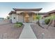 Charming home featuring manicured landscaping, an arched entryway, and a walkway leading to the inviting front door at 9183 W Shamel Ash Rd, Peoria, AZ 85383