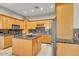 Kitchen featuring wooden cabinets, a kitchen island, and stainless steel appliances at 9183 W Shamel Ash Rd, Peoria, AZ 85383