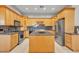 Kitchen featuring wooden cabinets, a kitchen island, and stainless steel appliances at 9183 W Shamel Ash Rd, Peoria, AZ 85383
