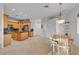 Open-concept kitchen with dining area featuring granite countertops, stainless steel appliances, and tile floors at 9183 W Shamel Ash Rd, Peoria, AZ 85383