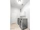 Bright laundry room with new washer and dryer units, cabinet space, and a white door at 9183 W Shamel Ash Rd, Peoria, AZ 85383