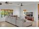 Inviting living room featuring a large sectional sofa, tile floors, and two windows at 9183 W Shamel Ash Rd, Peoria, AZ 85383
