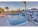 Inviting backyard pool with rock waterfall features and a basketball hoop at 9183 W Shamel Ash Rd, Peoria, AZ 85383