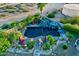 Inviting pool area with custom rock features, a waterfall, and lush landscaping at 9183 W Shamel Ash Rd, Peoria, AZ 85383