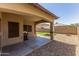 Covered patio area with grill, low maintenance rock landscaping and artificial turf in backyard at 923 E Randy St, Avondale, AZ 85323