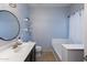 Bright bathroom with vanity, toilet, decorative shelves, and soaking tub area with modern fixtures at 923 E Randy St, Avondale, AZ 85323