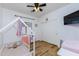 Bright bedroom with wood floors, playhouse bed, ceiling fan and organized closet at 923 E Randy St, Avondale, AZ 85323