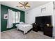 Comfortable bedroom featuring a ceiling fan, carpeted floors, neutral walls and large window at 923 E Randy St, Avondale, AZ 85323