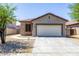 Charming single-story home featuring a two-car garage and stone veneer accents, creating an inviting curb appeal at 923 E Randy St, Avondale, AZ 85323