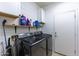 Modern laundry room featuring black stainless steel front-loading washer and dryer with shiplap accent wall at 923 E Randy St, Avondale, AZ 85323