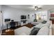Open-concept living room with hardwood floors, a ceiling fan, and natural light, perfect for relaxation at 923 E Randy St, Avondale, AZ 85323