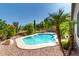 The backyard features a pool surrounded by desert landscape, mature trees, and a safety fence for relaxed outdoor living at 9465 W Tonopah Dr, Peoria, AZ 85382