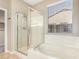 Bathroom with a glass enclosed shower, soaking tub, and a window with blinds at 9465 W Tonopah Dr, Peoria, AZ 85382