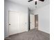 Bedroom with carpet flooring, neutral walls, closet, and doorway to an adjacent room at 9465 W Tonopah Dr, Peoria, AZ 85382
