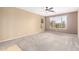 Bedroom featuring neutral paint, carpet, and large window with bright light at 9465 W Tonopah Dr, Peoria, AZ 85382