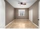 Bedroom with neutral walls, tile flooring, a ceiling fan, and closet with sliding doors at 9465 W Tonopah Dr, Peoria, AZ 85382