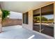 Covered patio features sliding glass doors, extending the living space outdoors, ideal for relaxation and entertaining at 9465 W Tonopah Dr, Peoria, AZ 85382