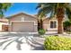 Charming single-story home featuring a manicured front yard and a two-car garage at 9465 W Tonopah Dr, Peoria, AZ 85382