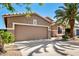 View of the front exterior of the home, with a driveway, garage, and a mature palm tree at 9465 W Tonopah Dr, Peoria, AZ 85382