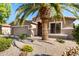 Exterior shot of a single-story home with desert landscaping and a view of the front entrance at 9465 W Tonopah Dr, Peoria, AZ 85382