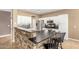 Bright kitchen with white cabinets, stainless steel appliances, and stone breakfast bar at 9465 W Tonopah Dr, Peoria, AZ 85382