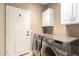 Laundry room with a washer and dryer set and cabinets at 9465 W Tonopah Dr, Peoria, AZ 85382