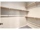 Walk-in closet with gray carpeting and wood shelving at 9465 W Tonopah Dr, Peoria, AZ 85382