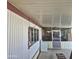 Exterior view of home featuring a partially enclosed porch with a laundry machine and screen door at 303 S Recker Rd # 98, Mesa, AZ 85206