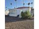 Cozy mobile home exterior featuring a satellite dish, shrubbery, and simple charm at 303 S Recker Rd # 98, Mesa, AZ 85206