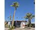Charming single-story home with multiple mature palm trees, a covered patio and low-maintenance gravel landscaping at 303 S Recker Rd # 98, Mesa, AZ 85206