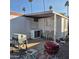 Exterior view with a grill, chairs and outdoor area, complemented by palm trees in the background at 303 S Recker Rd # 98, Mesa, AZ 85206