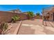 The backyard features desert landscaping, a covered patio, and ample sunshine for outdoor enjoyment at 105 W Monona Dr, Phoenix, AZ 85027