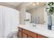 Bright bathroom with a single sink vanity, toilet, and shower with curtain at 105 W Monona Dr, Phoenix, AZ 85027