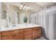 Bathroom featuring a double sink vanity, large mirror and bath tub with shower at 105 W Monona Dr, Phoenix, AZ 85027