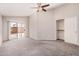 Carpeted bedroom featuring a sliding glass door to the patio, ceiling fan, and closet at 105 W Monona Dr, Phoenix, AZ 85027