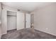 Neutral bedroom featuring sliding-door closet and doorway with carpet flooring at 105 W Monona Dr, Phoenix, AZ 85027