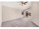Open bedroom with carpeted floors, a ceiling fan, and sliding glass door to the patio at 105 W Monona Dr, Phoenix, AZ 85027