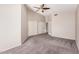 Spacious carpeted bedroom featuring a ceiling fan and an adjoining doorway at 105 W Monona Dr, Phoenix, AZ 85027