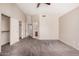 Spacious bedroom featuring a ceiling fan and a doorway into a bathroom at 105 W Monona Dr, Phoenix, AZ 85027