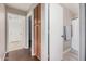 Hallway featuring a wood floor, linen closet, and a doorway to a bathroom at 105 W Monona Dr, Phoenix, AZ 85027