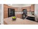 Kitchen featuring wood cabinets, black appliances, tile backsplash, and breakfast bar seating at 105 W Monona Dr, Phoenix, AZ 85027
