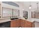 Open kitchen featuring wood cabinets, black sink and appliances, and an exterior view at 105 W Monona Dr, Phoenix, AZ 85027