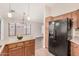 Open kitchen with a black refrigerator, wood cabinets, and breakfast bar seating at 105 W Monona Dr, Phoenix, AZ 85027