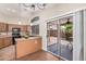 Eat-in kitchen featuring wood cabinets, black appliances, and sliding glass doors to the patio at 105 W Monona Dr, Phoenix, AZ 85027