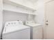 Laundry room with stacked shelves and appliances including a washer and dryer at 105 W Monona Dr, Phoenix, AZ 85027