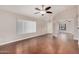 Open living room with rich wood floors, a ceiling fan, and plentiful natural light at 105 W Monona Dr, Phoenix, AZ 85027