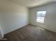 Cozy bedroom featuring plush carpeting and a window letting in natural light at 13142 E Aster Ln, Florence, AZ 85132